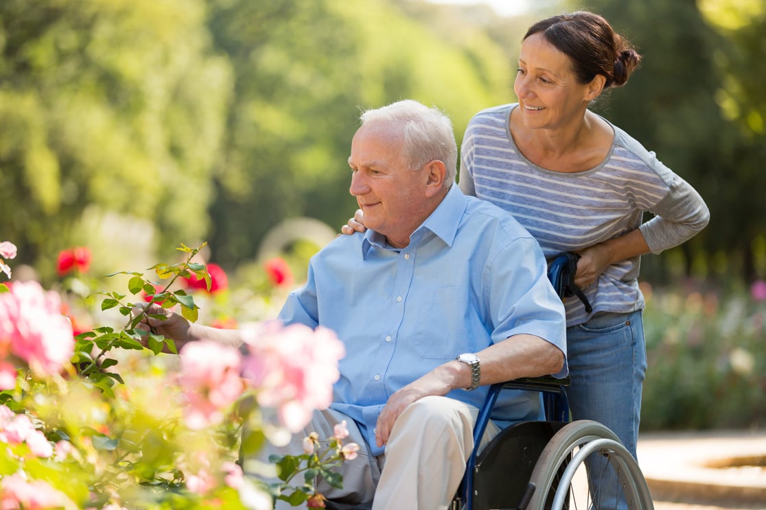 Assisted living – caregiver and senior man on a wheelchair